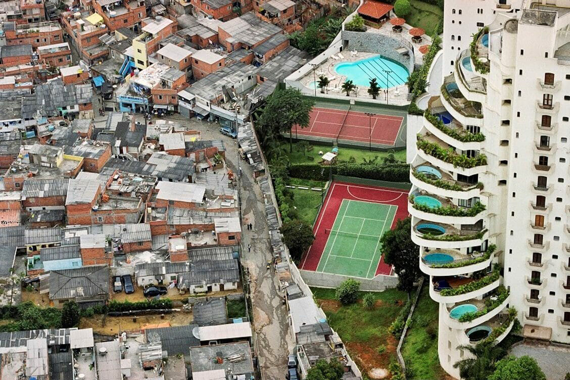 Tuca Vieira’s 2004 photograph of Paraisopolis, a favela in Sao Paulo, Brazil showing the divide between rich and poor