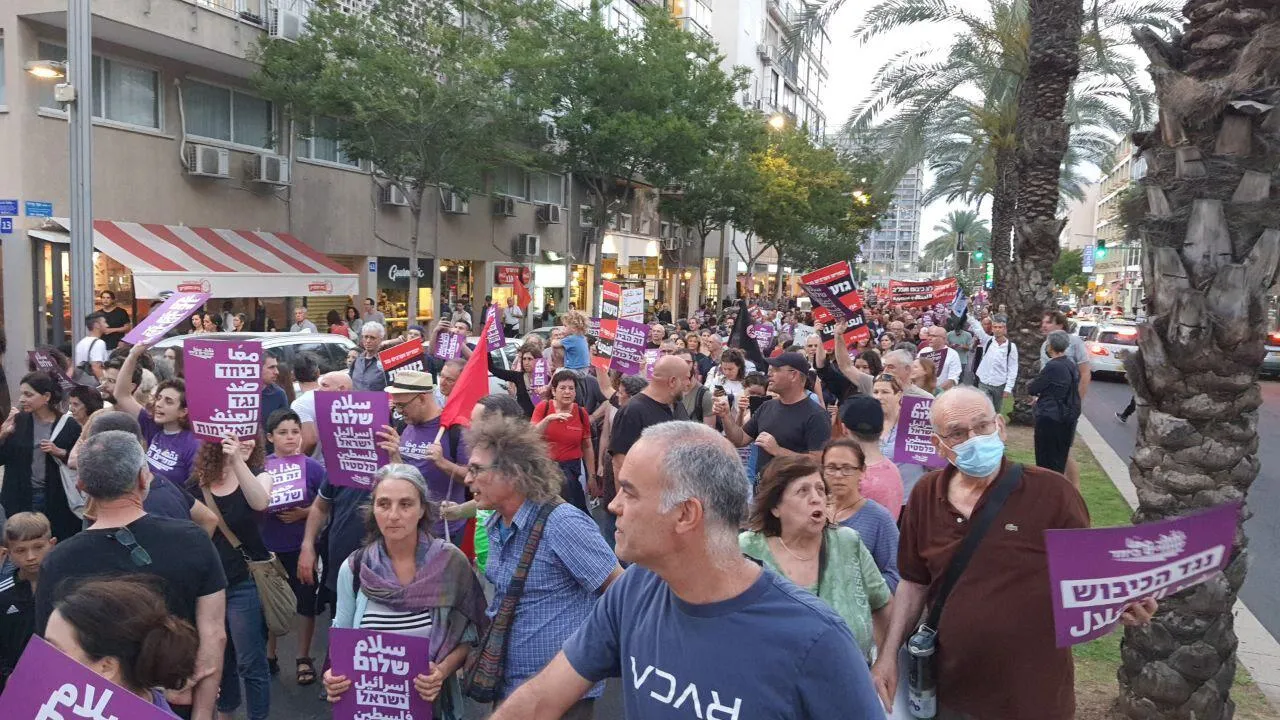 People marching along a street with banners