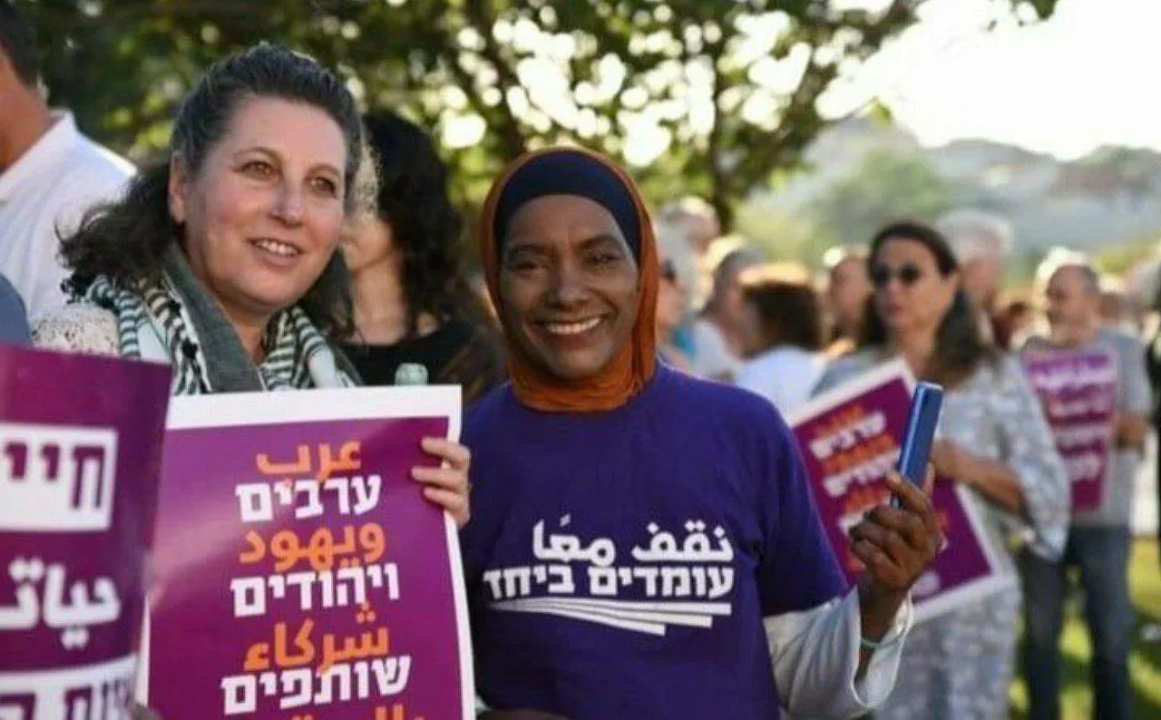 A closeup of smiling people from the rally