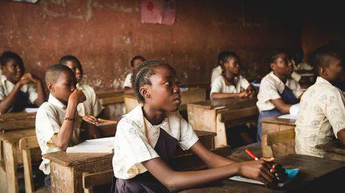 Nigerian children sitting at desks in school