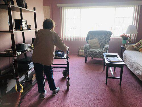 A person using a walker in their living room