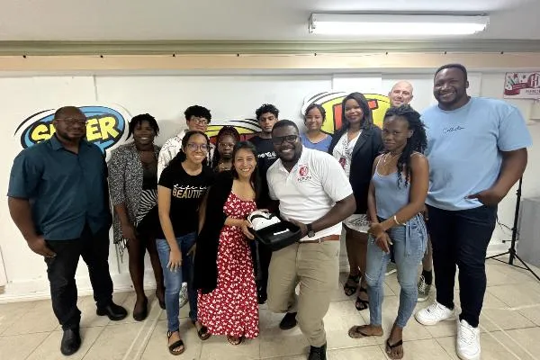 Group of adults and youth smiling at the camera