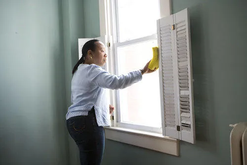 A care worker cleans windows