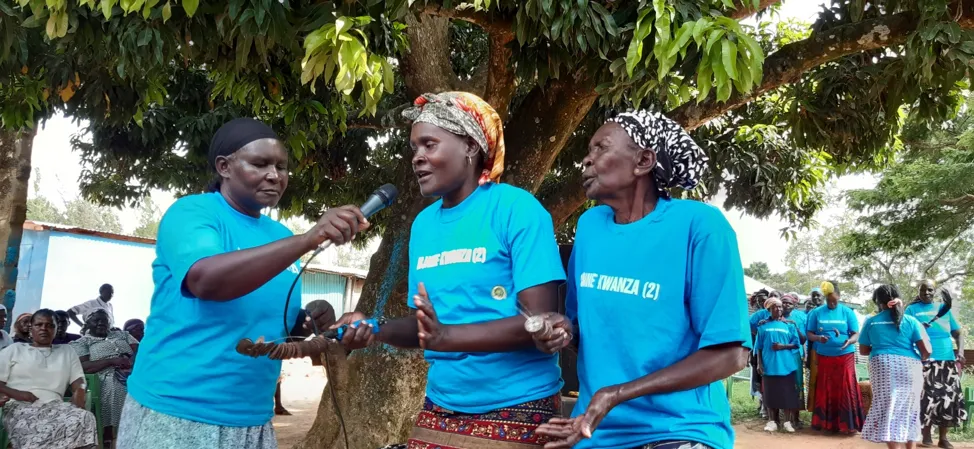 People from the Widows Theatre perform under a tree at the Kobare Market