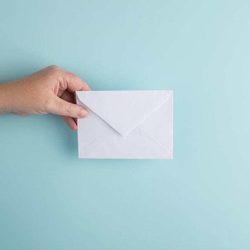 Person holding an envelope
