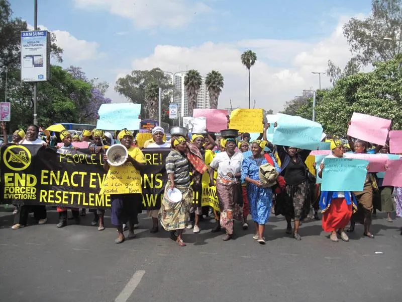 A large group of people protesting forced evictions