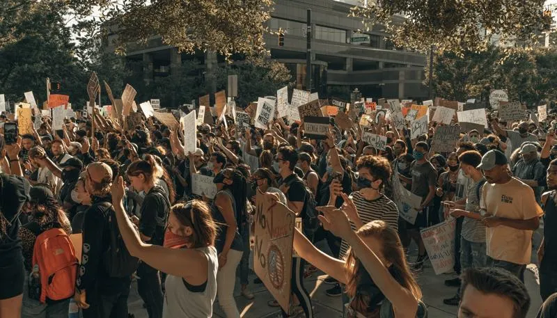 A large group of people marching with "Black Lives Matter" banners