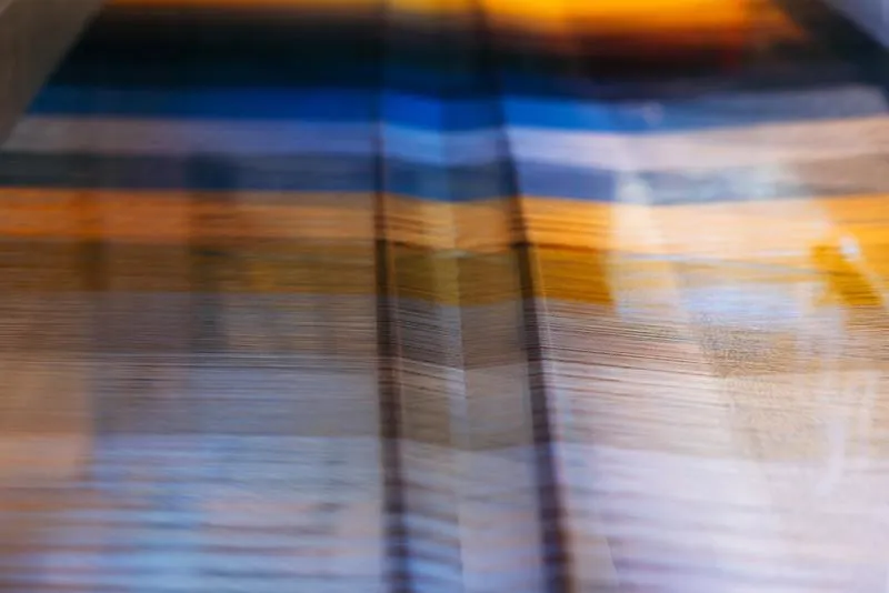 Blue and yellow silk being woven