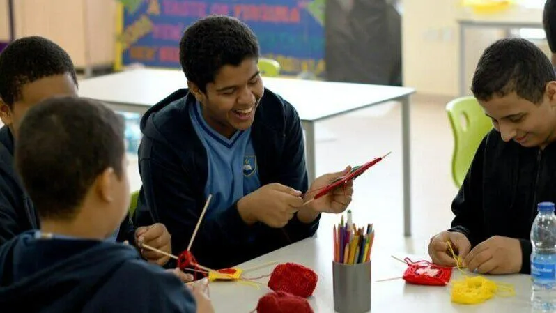 A group of young people making things at a table