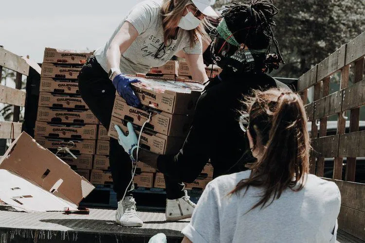 People unloading boxes from a truck