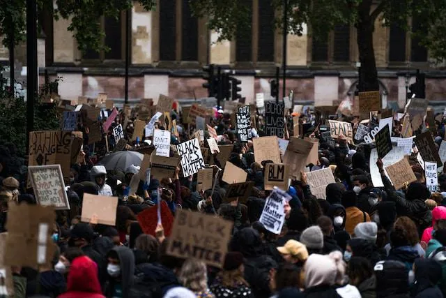 protesters holding signs in a black lives matter - protest