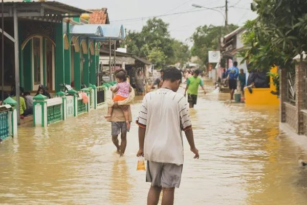  People walking on a flooded street during daytime