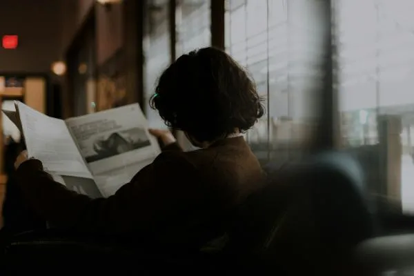 A woman reading a newspaper