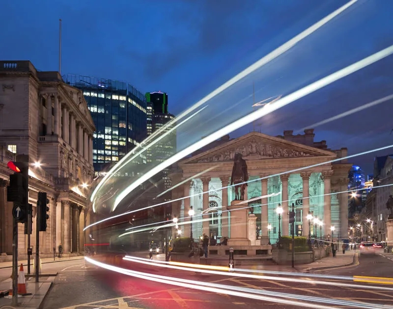 A city at night with vehicle lights streaming by