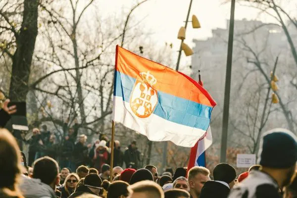 Crowd waving a Serbian flag